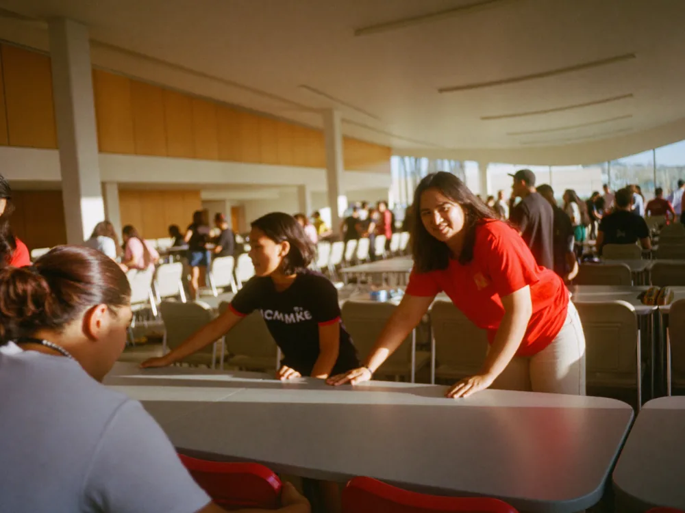 Volunteers setting up tables and chairs for a community event.