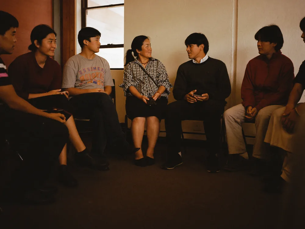 Youth and elders seated together in a community conversation circle.